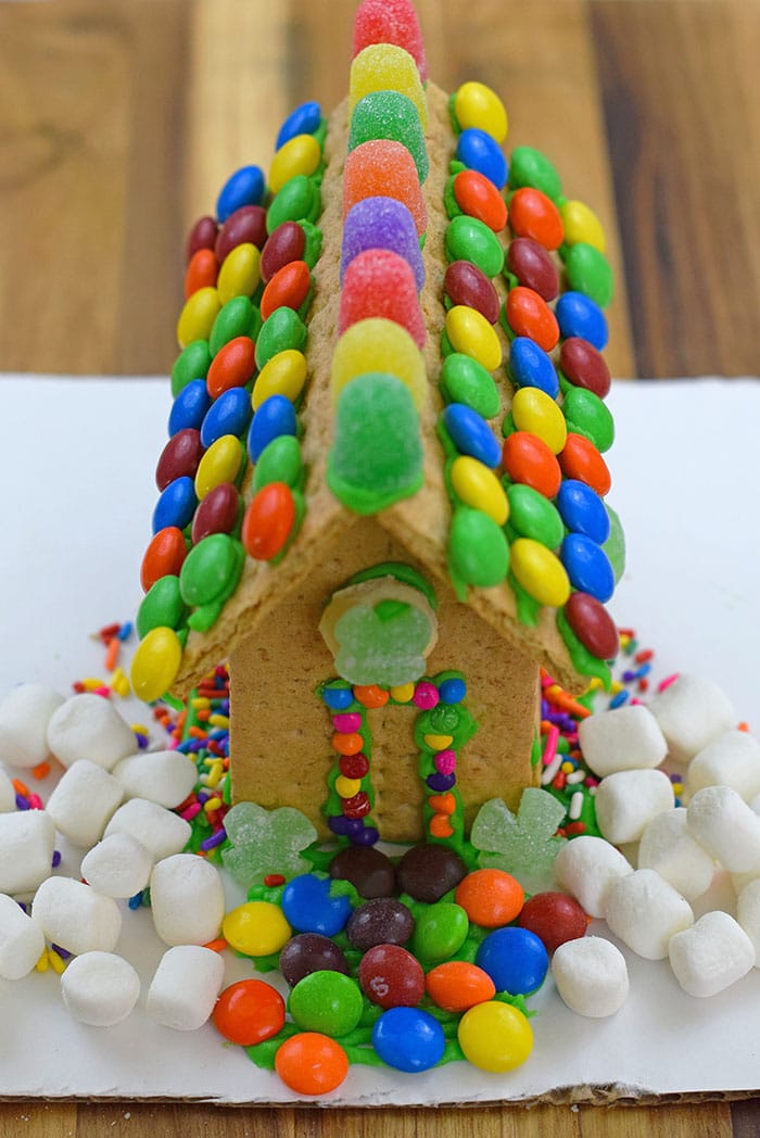 Make a fun and edible kids craft this St. Patrick's Day, a Graham Cracker Leprechaun House. Gather rainbow colored candies, Decorating Icing, and graham crackers, and you're all set!