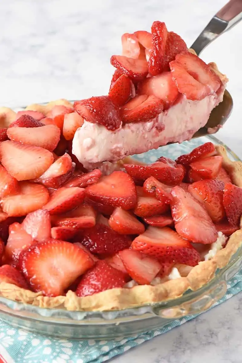 slicing and serving fresh strawberry pie
