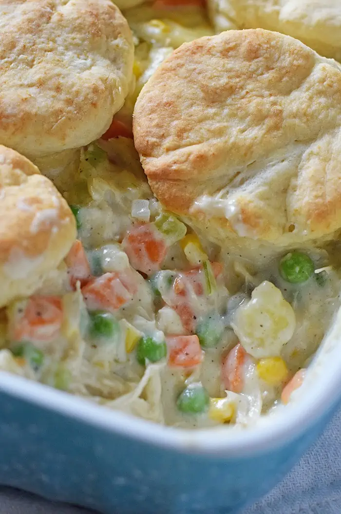 Chicken Pot Pie with biscuits, filled with a medley of colorful vegetables in a creamy sauce. Makes a delicious dinner idea!