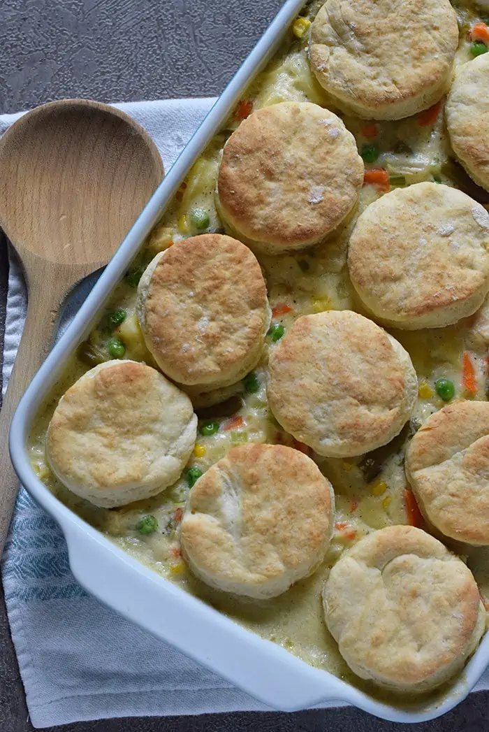 Chicken Pot Pie with Grandma's biscuits, filled with vegetables in a creamy sauce that’s seasoned with sage. Ultimate comfort food recipe.