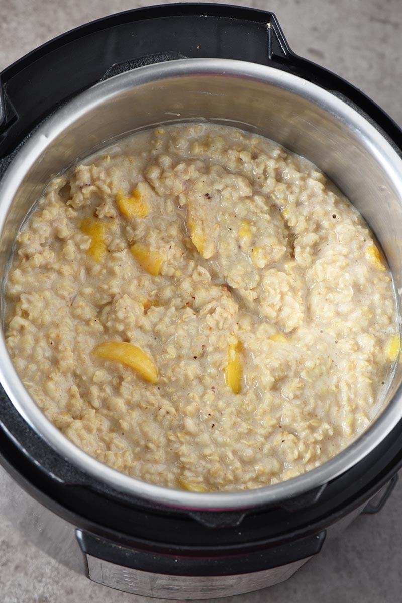 cooked peaches and cream Instant Pot oatmeal in the Instant Pot pressure cooker