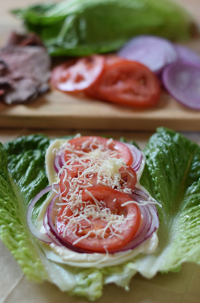 Low Carb Roast Beef Lettuce Wraps are filled with onion, tomatoes, cheese, and roast beef. Only a few ingredients and 10 minutes to make!