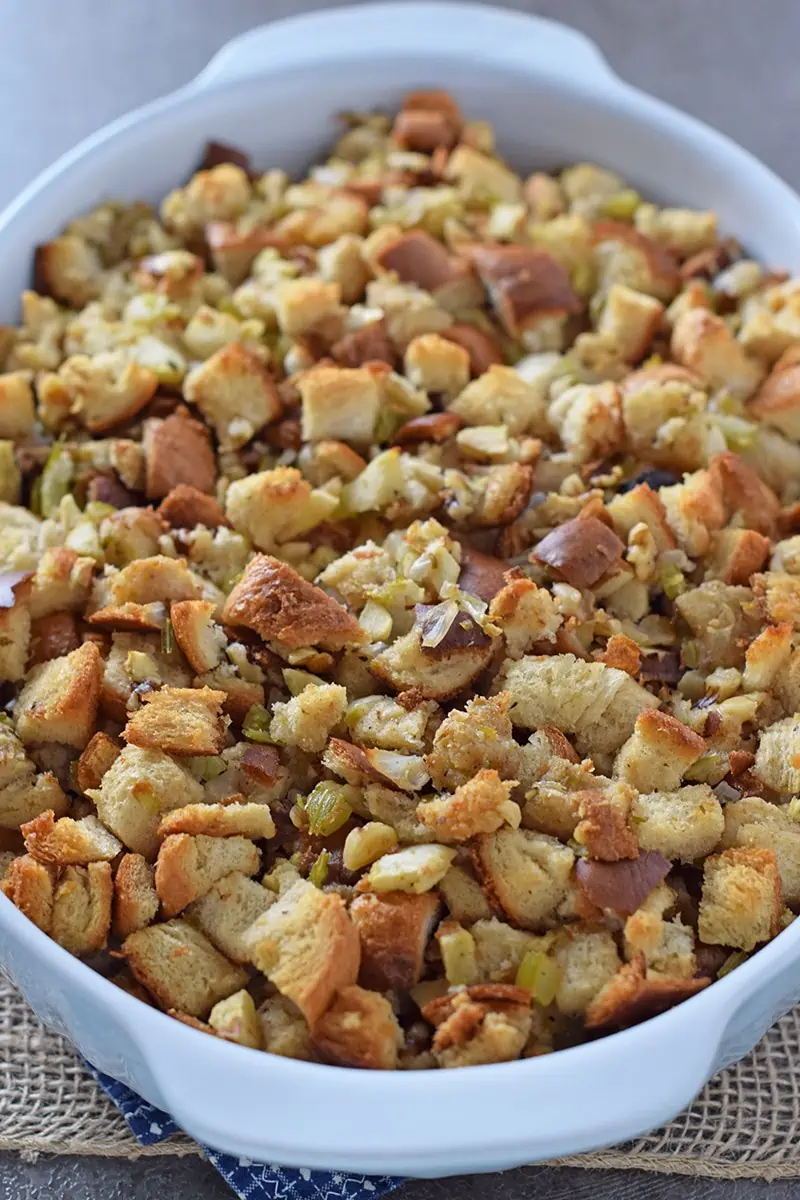 Make a classic Thanksgiving side dish with this old-fashioned homemade recipe for Apple Walnut Bread Stuffing. Delicious stuffing recipe that’s also easy to make!