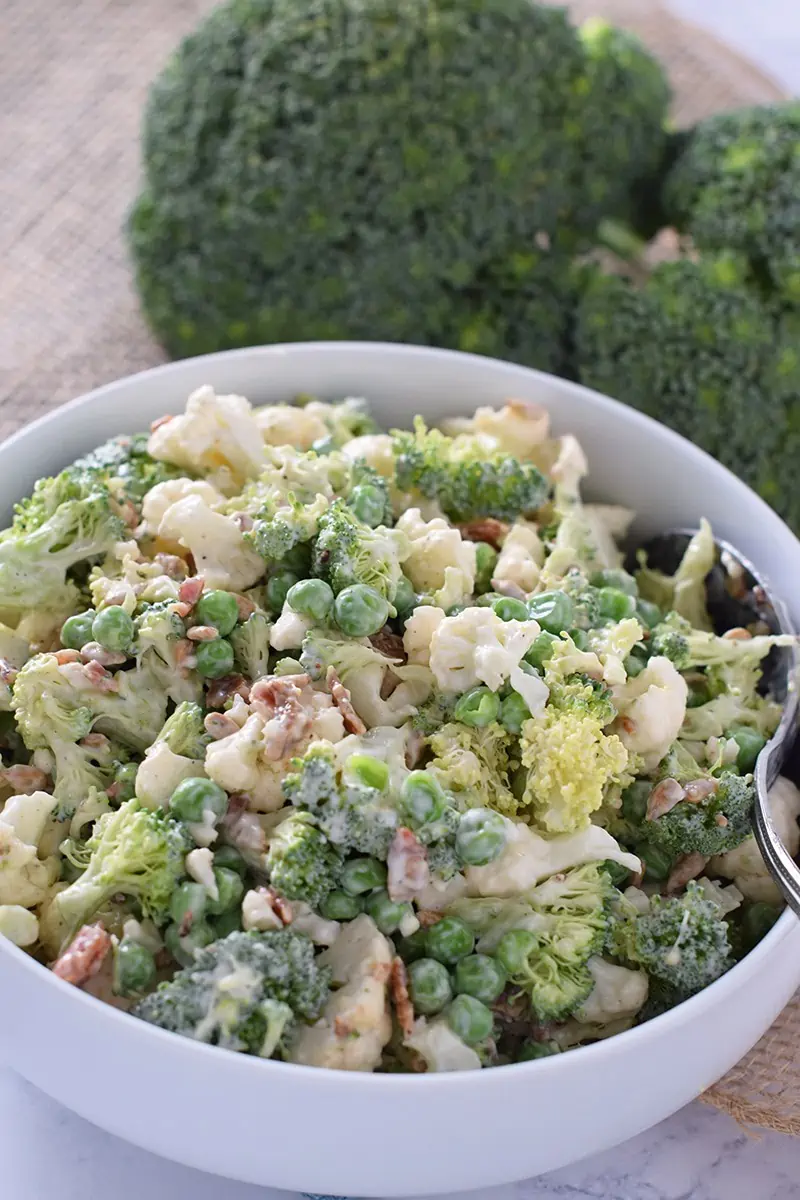 Serve Easy Broccoli Salad at your next family get together or with the average weeknight meal. Delicious side dish filled with broccoli, bacon, sunflower seeds, and more.