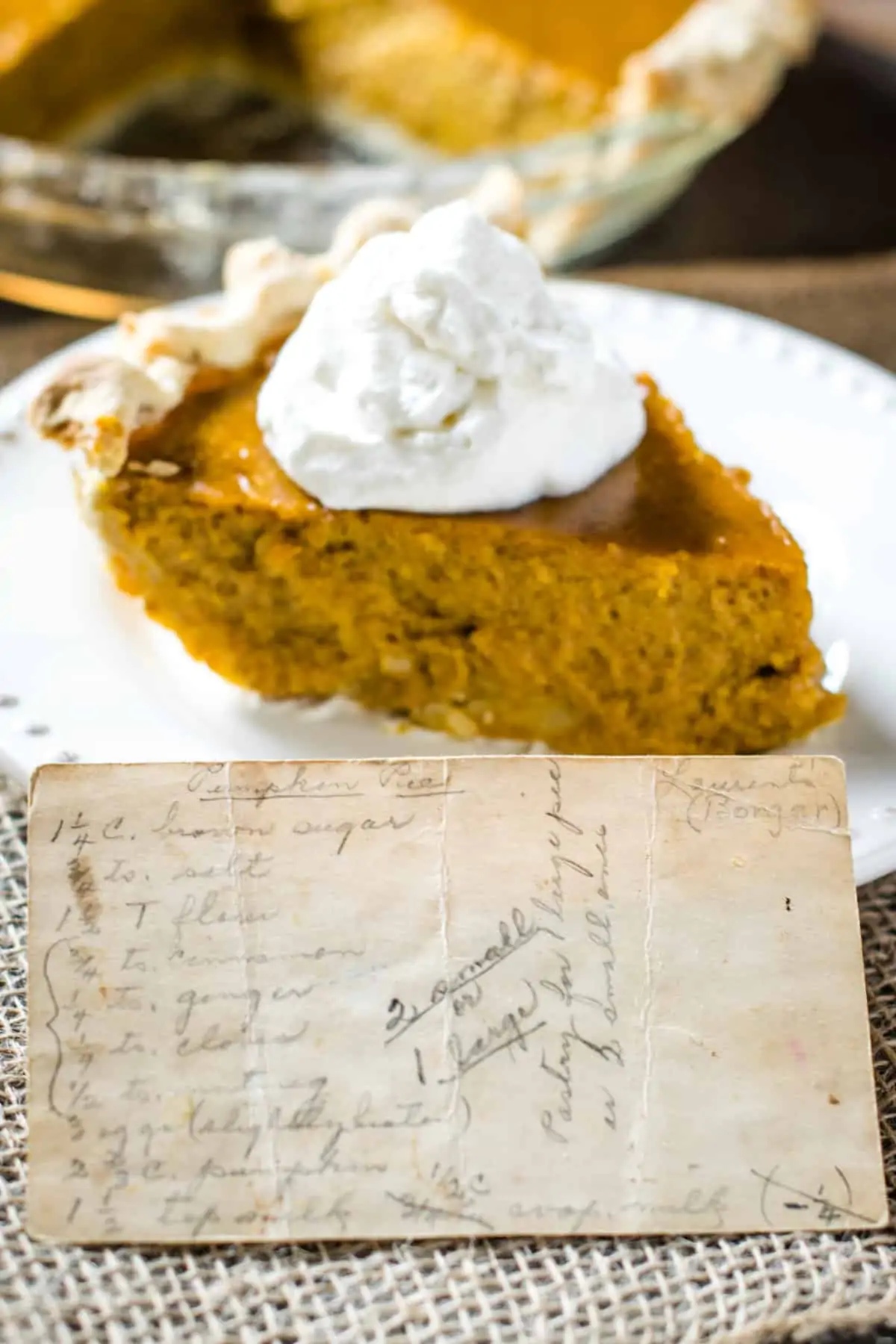 Grandma's pumpkin pie recipe card with slice of pie in background