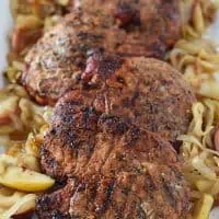 Grill up Maple Pork Chops and top them off with apples and onions for a weeknight meal your family will love. Delicious recipe!