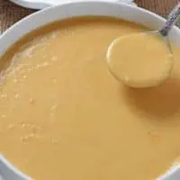 homemade ham gravy recipe in white serving bowl with spoon