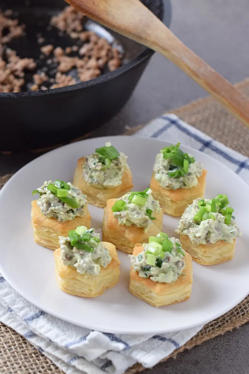Maple Sausage Stuffed Pastry Bites, made with puff pastry cups, cream cheese, spinach, and Ranch dressing mix. They’re so scrumptious, all your holiday party guests will love them!