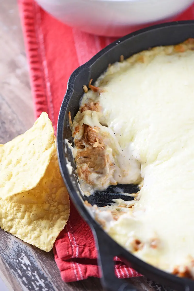 Make a Creamy BBQ Chicken Dip to pair with tortilla chips, crackers, and raw vegetables. Delicious party appetizer and easy snack idea!