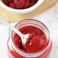 Spoonful of Homemade Raspberry Sauce in a Jar