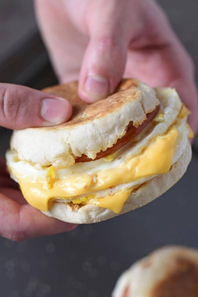 holding a homemade McDonald's Egg McMuffin breakfast sandwich