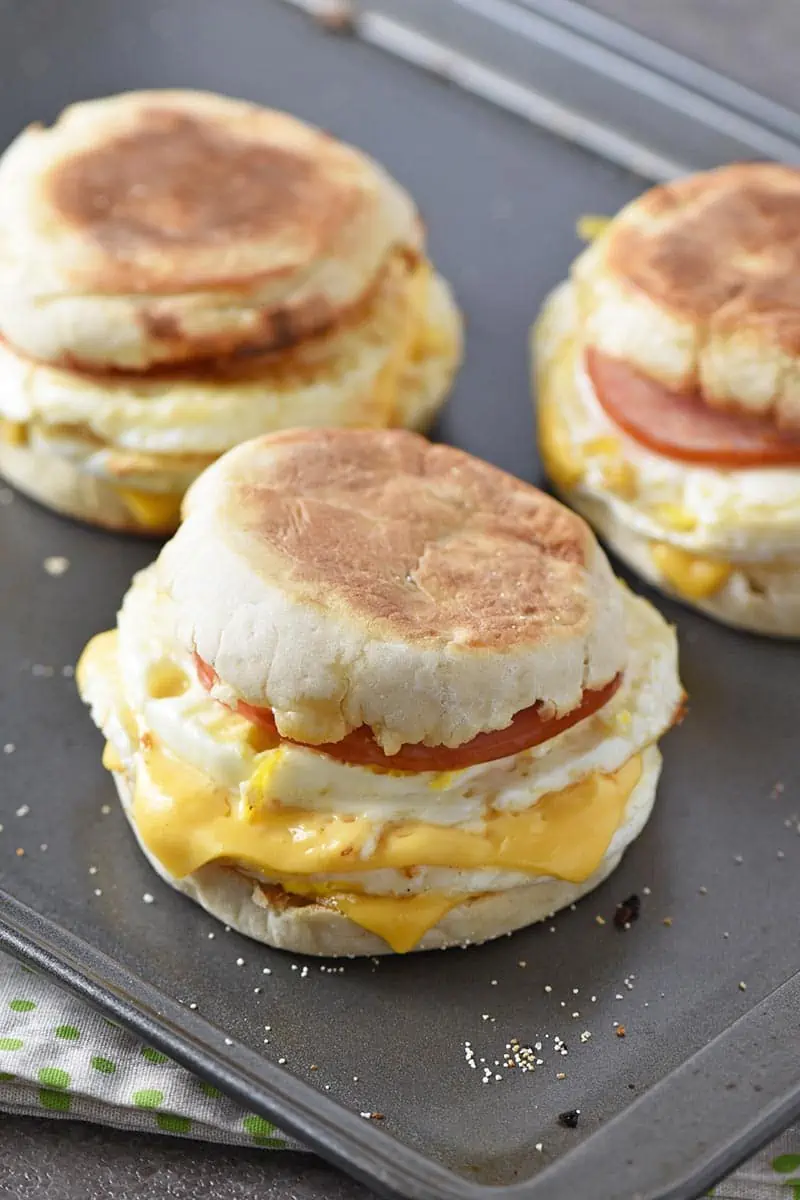 homemade Egg McMuffin on baking sheet with other breakfast sandwiches