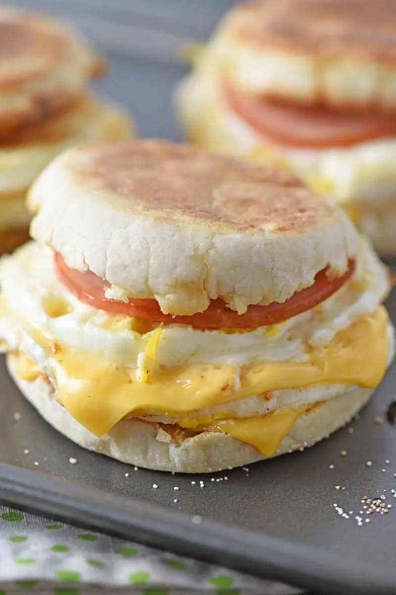 homemade Egg McMuffin, McDonald's copycat recipe, on baking sheet with other breakfast sandwiches