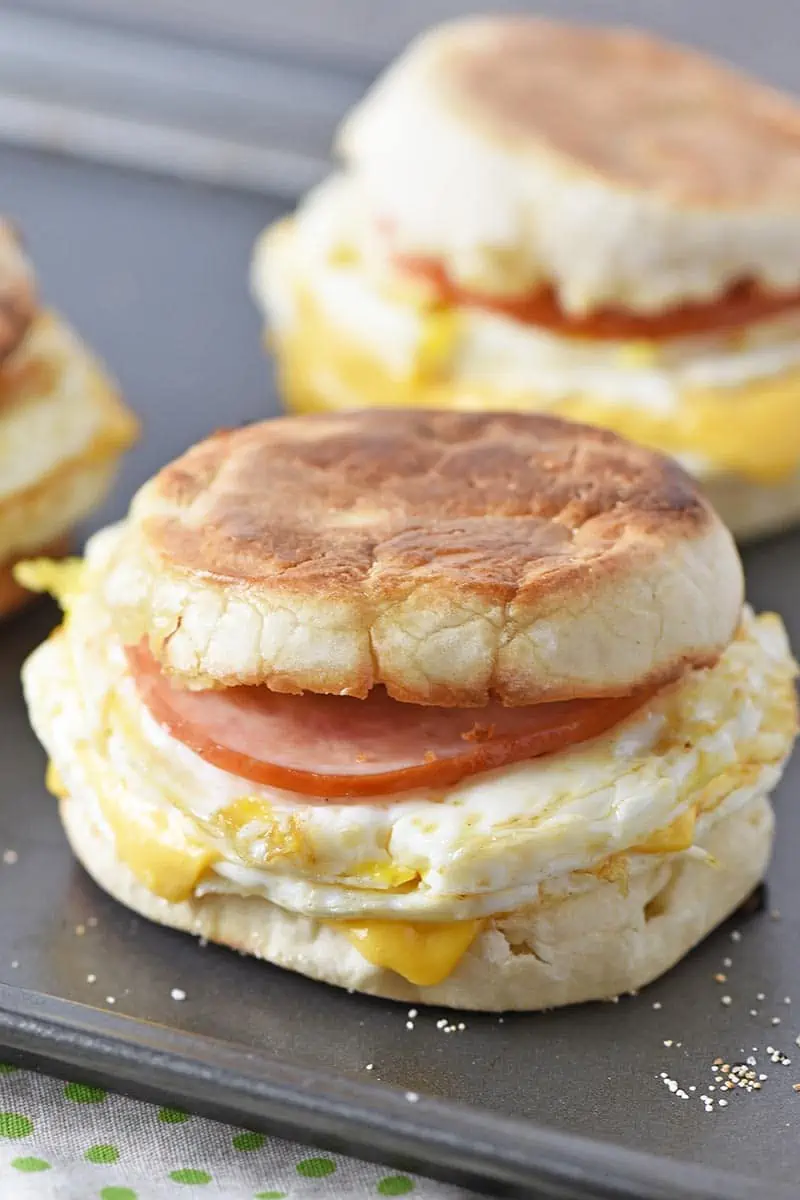 a delicious English McMuffin made with Canadian bacon, eggs, and cheese on an English muffin, sitting on a baking sheet