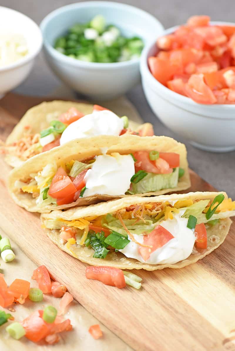 loaded pressure cooker chicken tacos on a cutting board