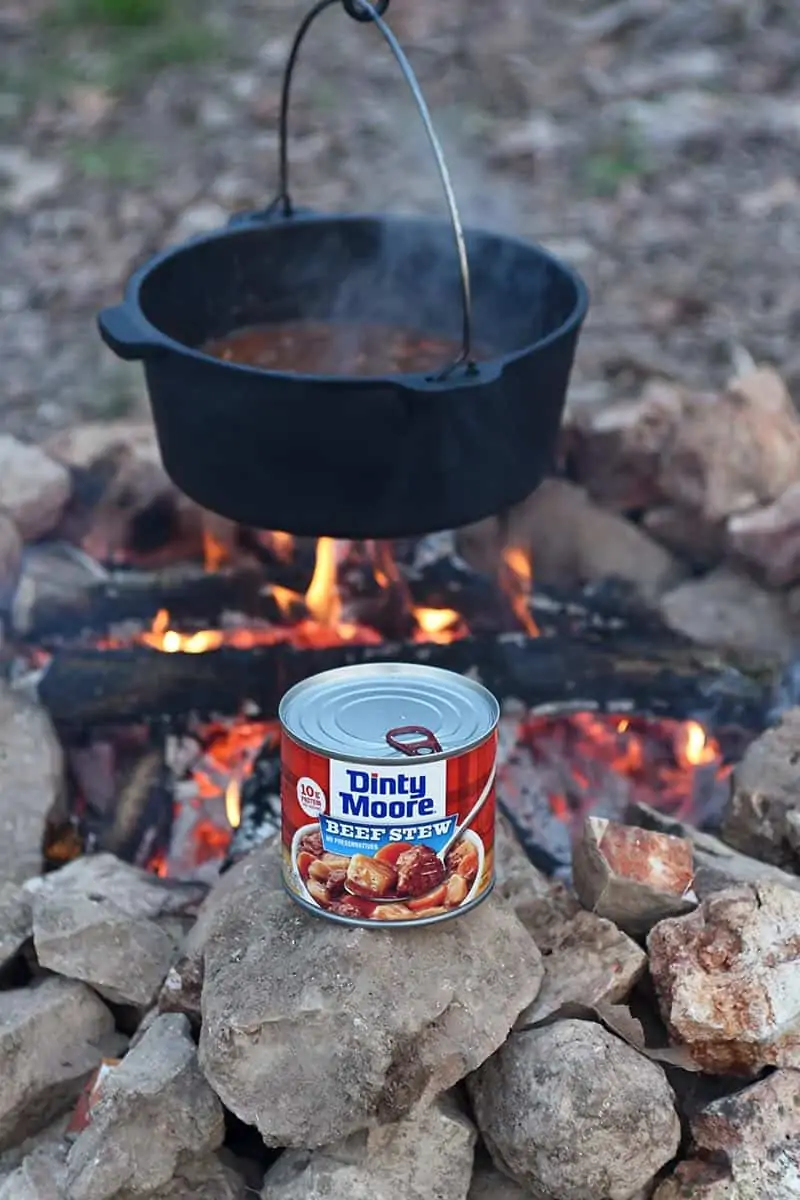 cooking DINTY MOORE® Beef Stew in a Dutch oven over the fire