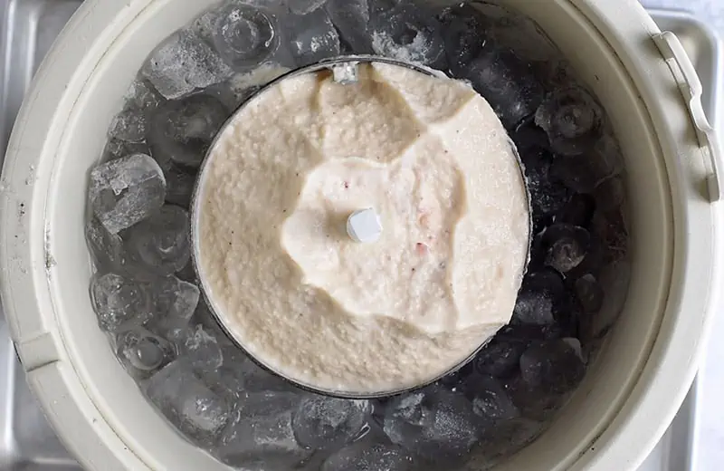 remove lid from ice cream maker to reveal homemade strawberry ice cream