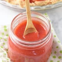 spoonful of homemade strawberry sauce in mason jar
