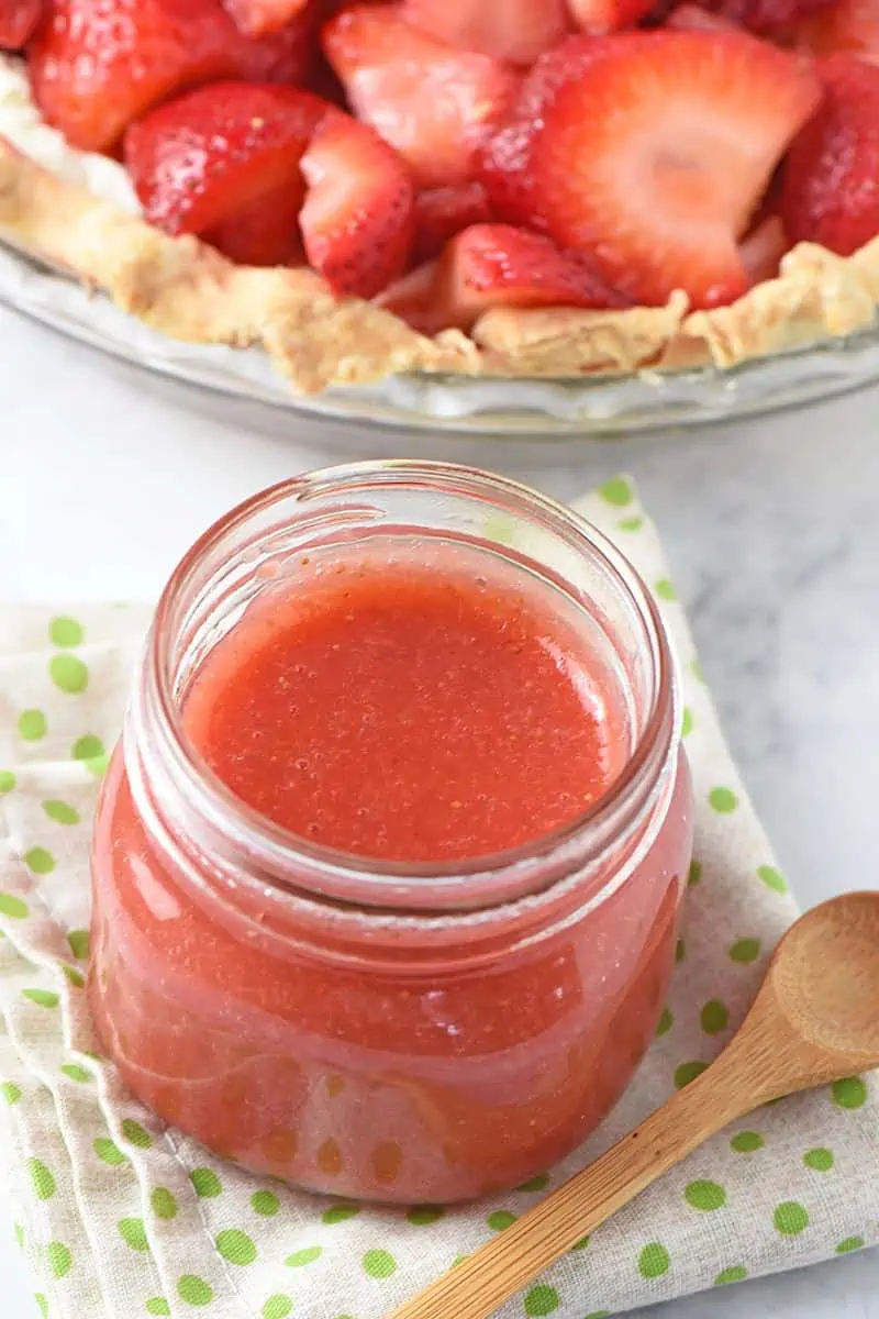 homemade strawberry sauce recipe in mason jar with strawberry pie