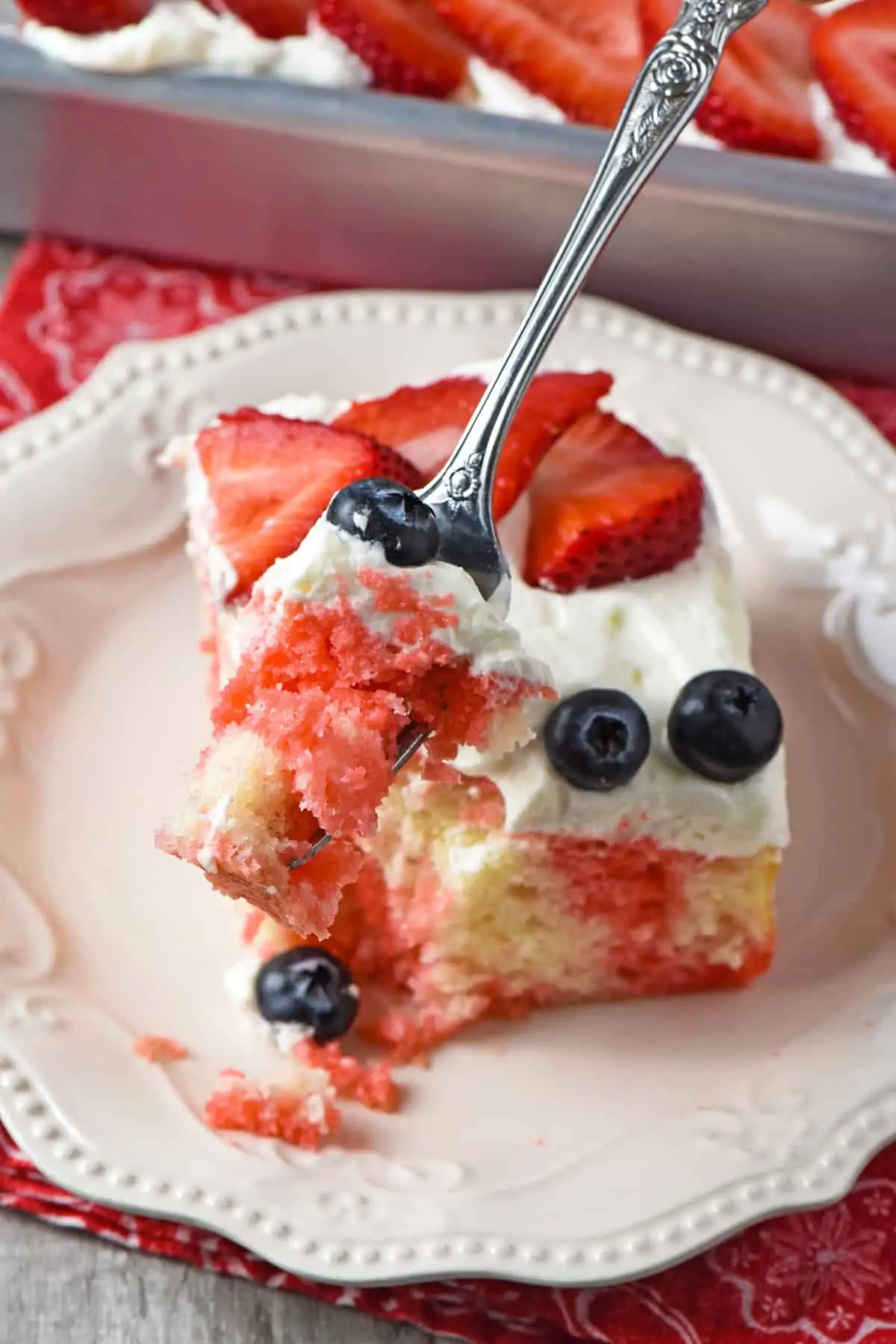 slice and bite of 4th of July cake on fork