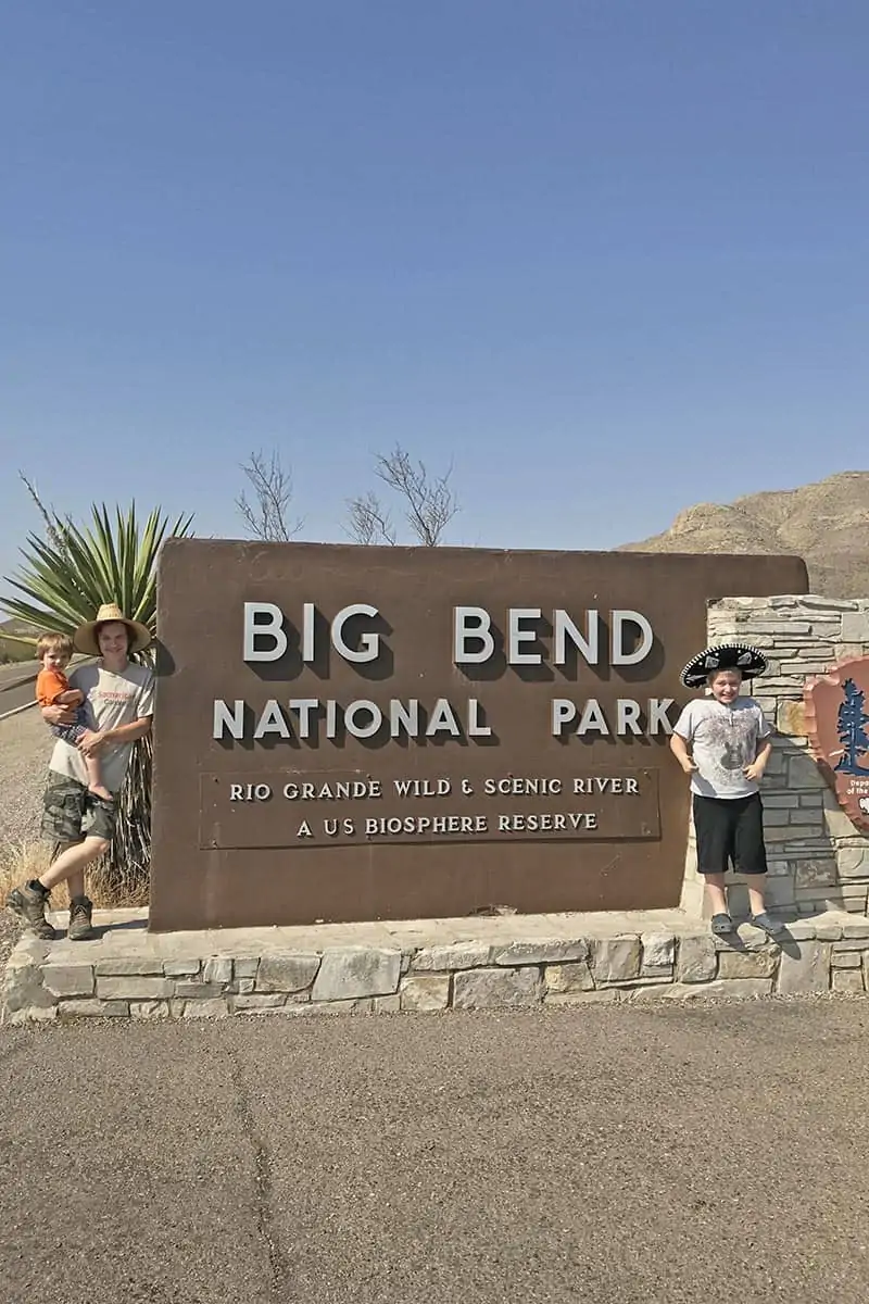 kids with Big Bend National Park sign at park entrance in Texas