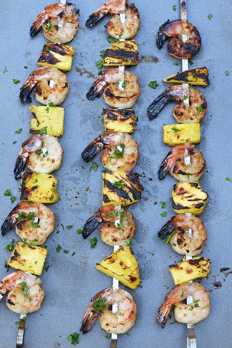 maple bourbon grilled shrimp kabobs with pineapple on a cookie sheet