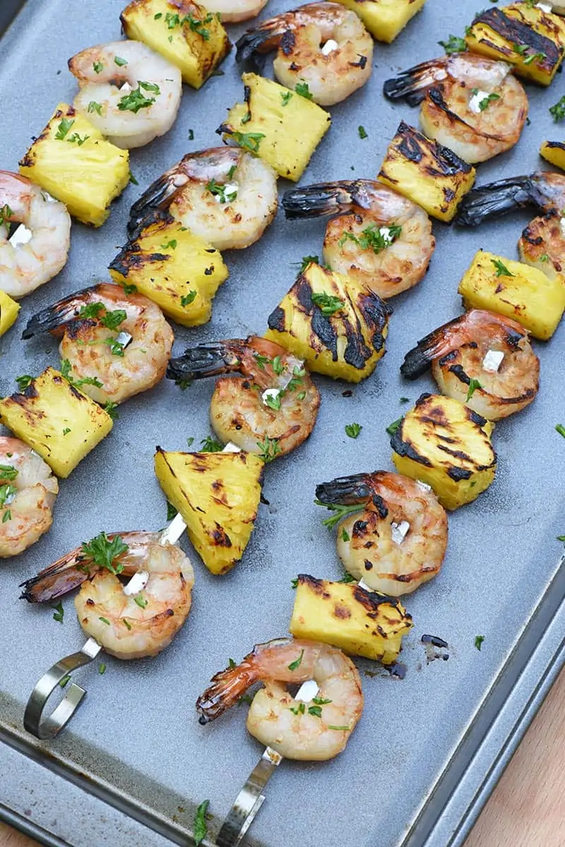 grilled maple bourbon shrimp kabobs with pineapple chunks and bits of parsley