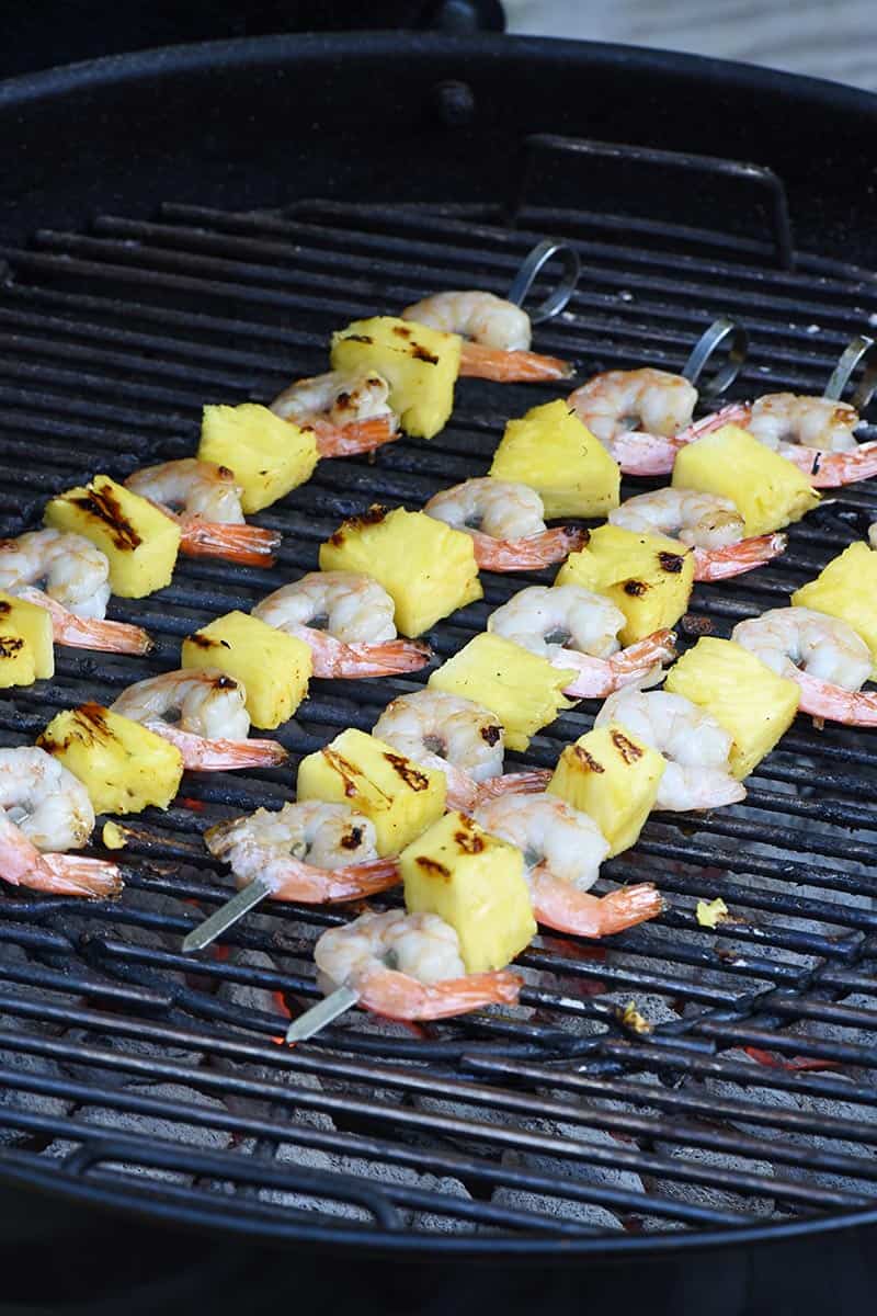 grilling marinated shrimp kabobs on a charcoal grill