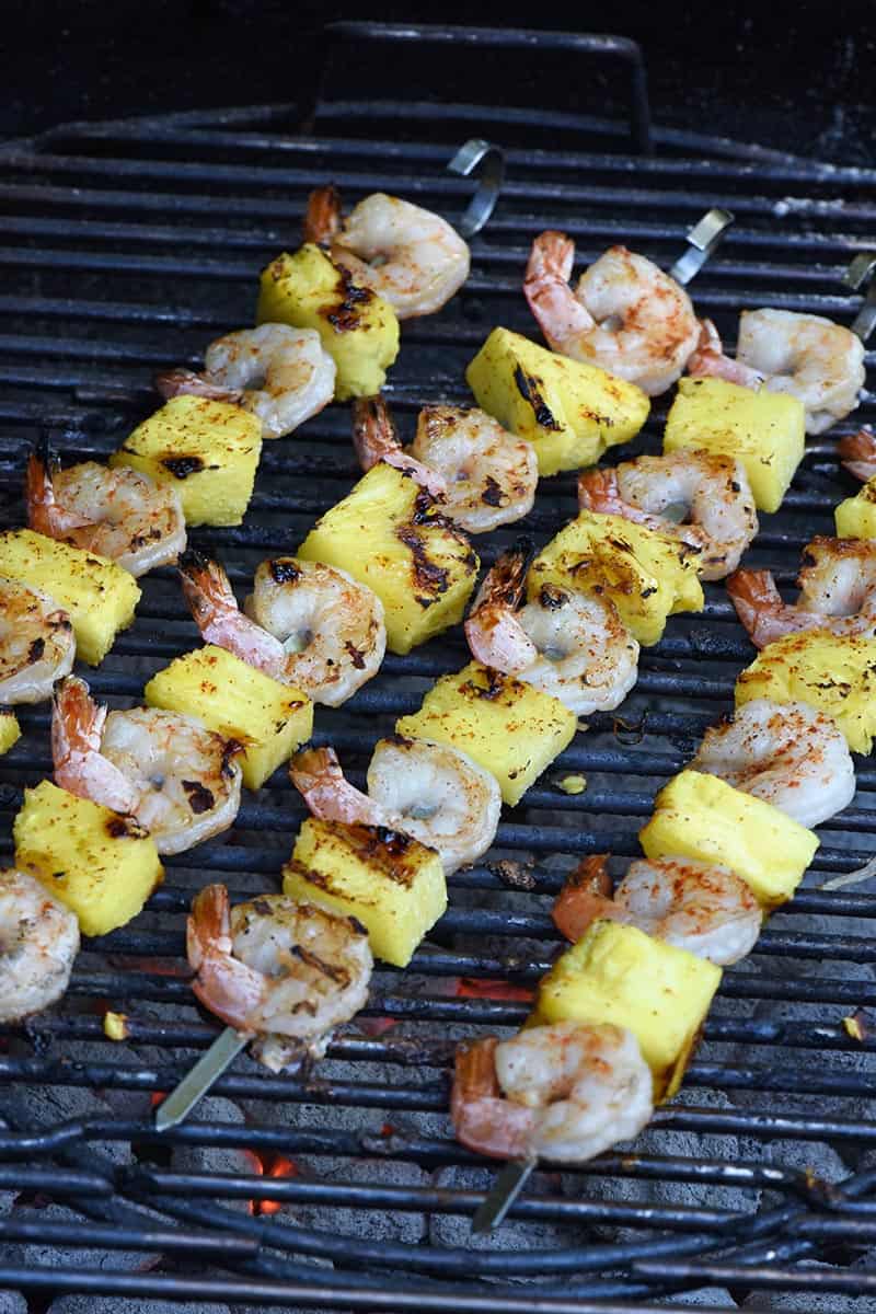 grilled shrimp recipe for maple bourbon grilled shrimp kabobs sprinkled with cayenne pepper on the grill