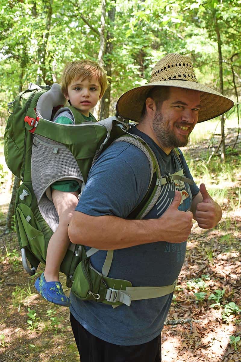 dad and toddler son hiking with Osprey baby carrier backpack in Northwest Arkansas