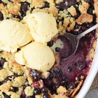 easy blueberry cobbler recipe in a baking dish with vanilla ice cream