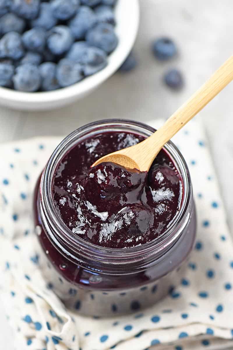 wooden spoon in mason jar of homemade small batch blueberry pie filling