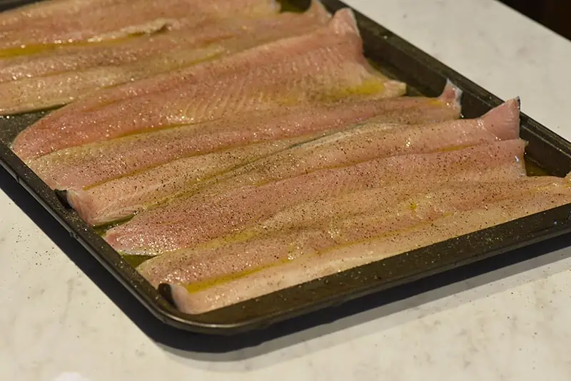 grill fish with a coating of olive oil and salt and pepper seasoning