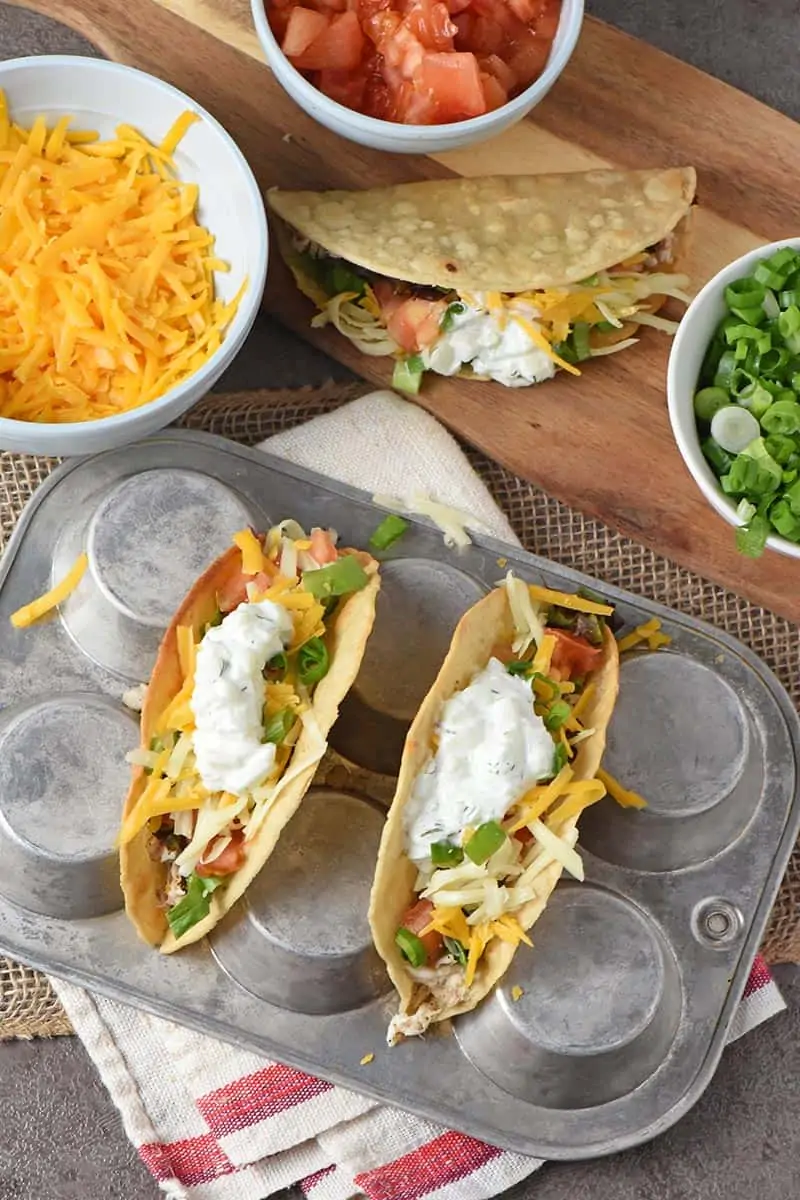 fish tacos recipe ingredients, including cheese, tomatoes, and green onions