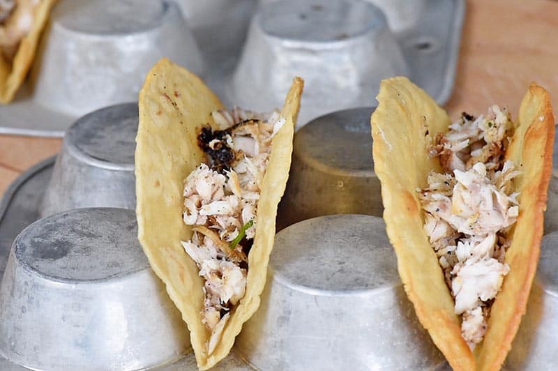 start with a layer of fish in a crispy taco shell for fish tacos