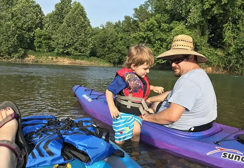 exploring the creek while kayaking with kids