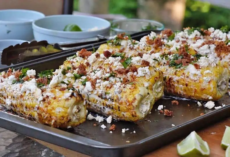 Mexican corn on the cob on a baking sheet