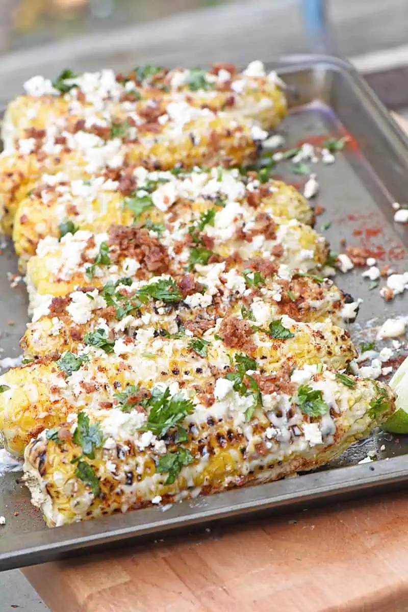 grilled Mexican corn on a baking sheet