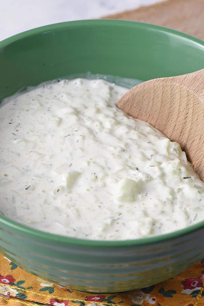 low carb recipe for tzatziki sauce in green pioneer woman bowl with wooden spoon
