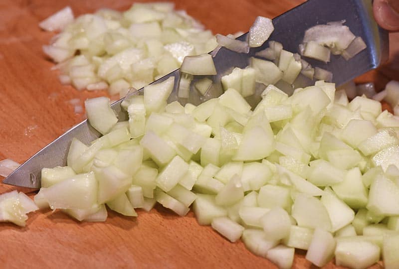 chopping cucumber for tzatziki sauce recipe
