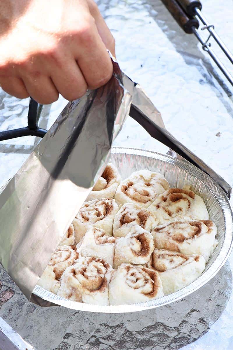 aluminum foil sling to lower cinnamon rolls into Dutch oven for cooking