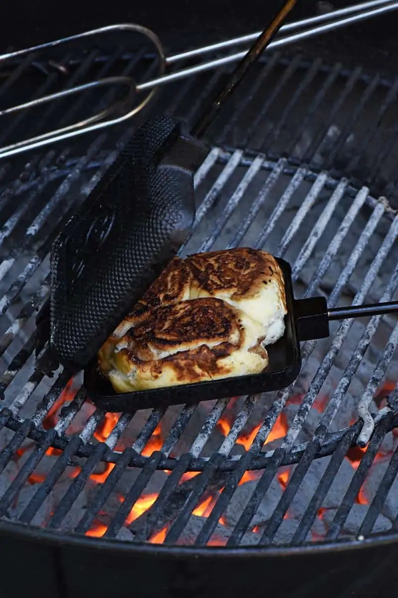 grilling pie iron cinnamon rolls in a pie iron on the grill