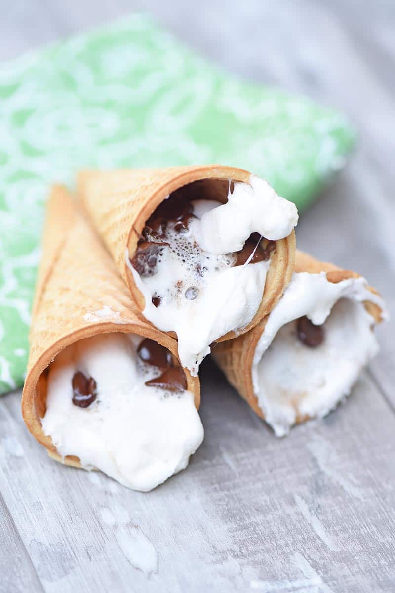 melted marshmallows and chocolate chips in sugar cones for campfire sugar cone s'mores recipe