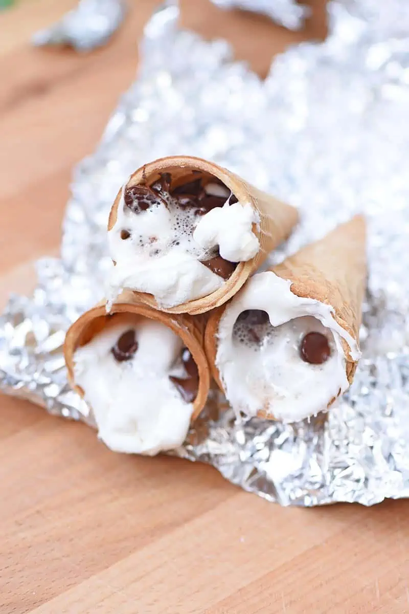 melted sugar cone s'mores sitting on foil cooling before eating