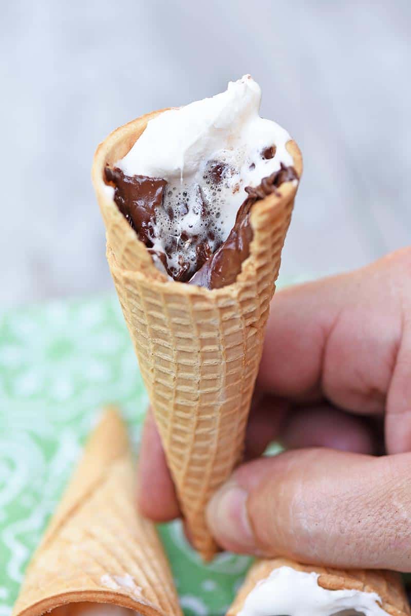 bite out of sugar cone s'more with melted chocolate and marshmallow