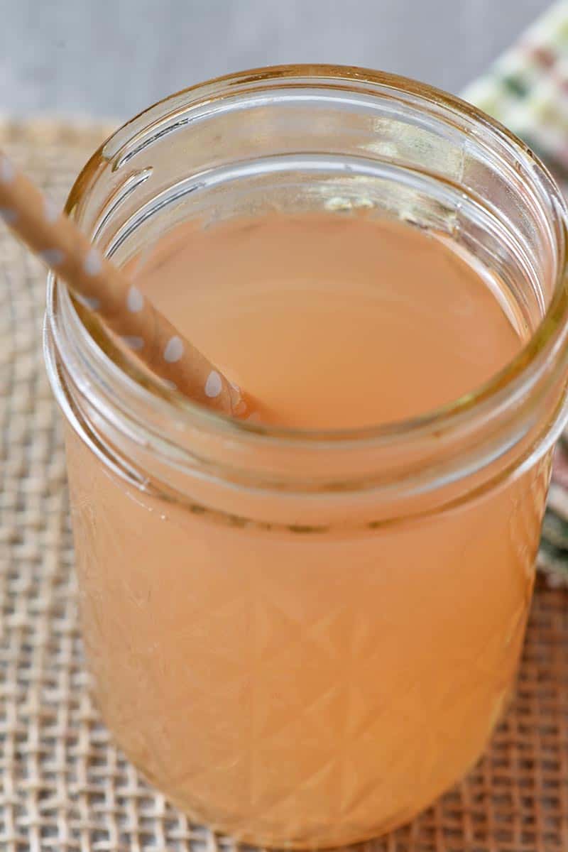 apple juice in a jar with a paper straw