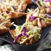 asian chicken salad wonton cups in cast iron muffin pan