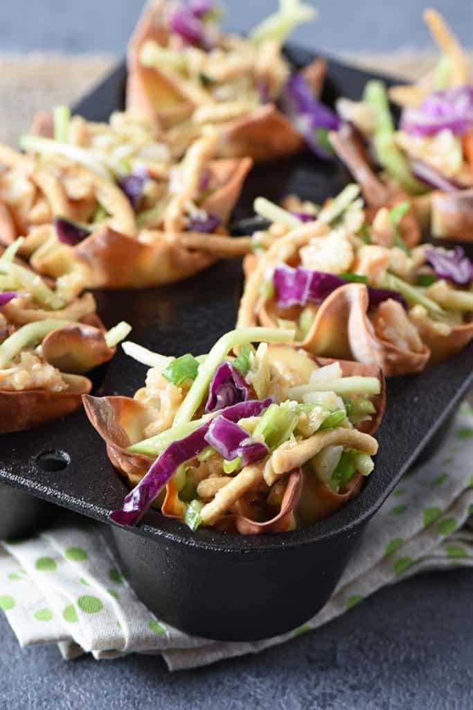 asian chicken salad wonton cups in cast iron muffin pan