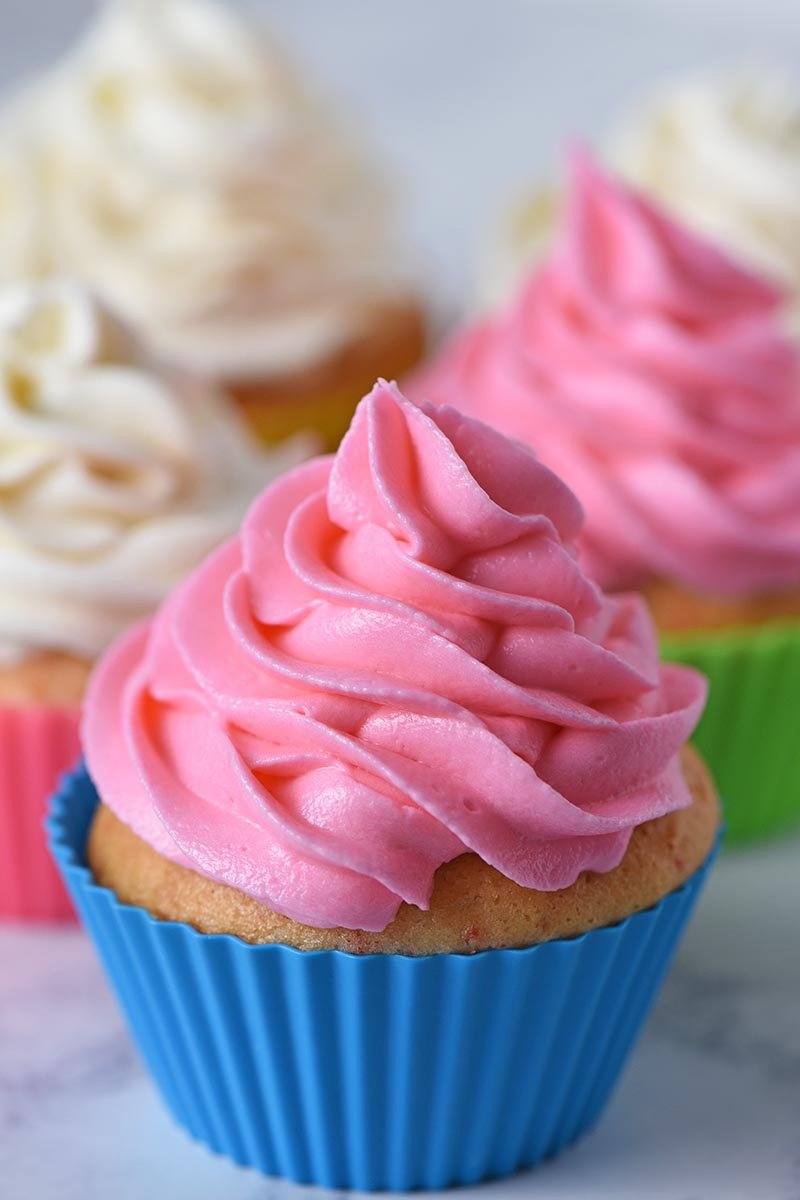 pink buttercream icing for piping onto cupcakes, the best buttercream frosting recipe