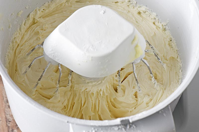 mixing up the best buttercream frosting in a mixer